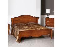 Foto letto matrimoniale in legno con testata sagomata per arredi in stile classico